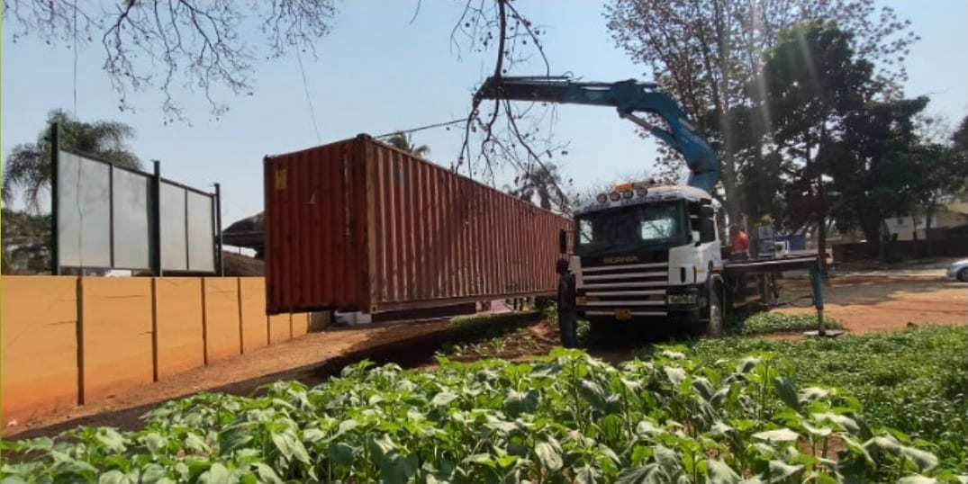 A shipping container craned into place for a Kapture build